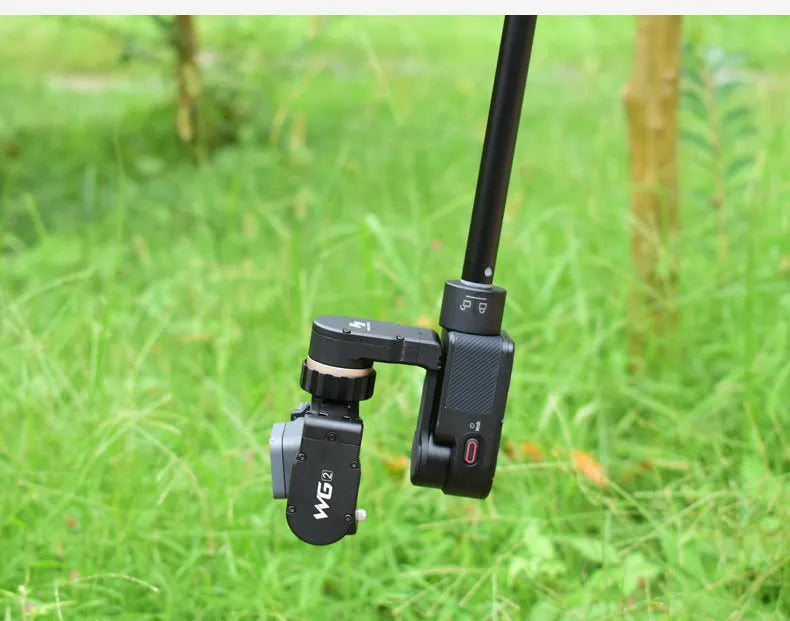 Black retractable aluminium selfie stick extended, with a smartphone mounted on the holder.