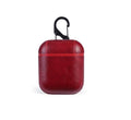 Genuine leather protective case for Apple AirPods charging case in black, brown, light brown, and red.