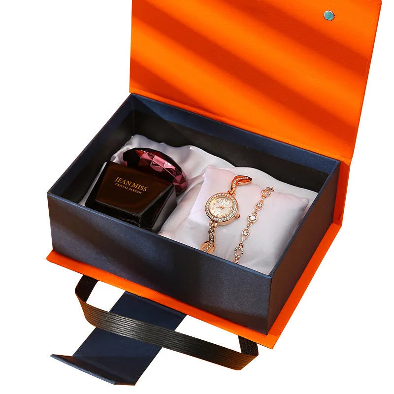 Gift set box containing watch, lipstick, perfume, and earrings in a red gift box with leather strap and metal case
