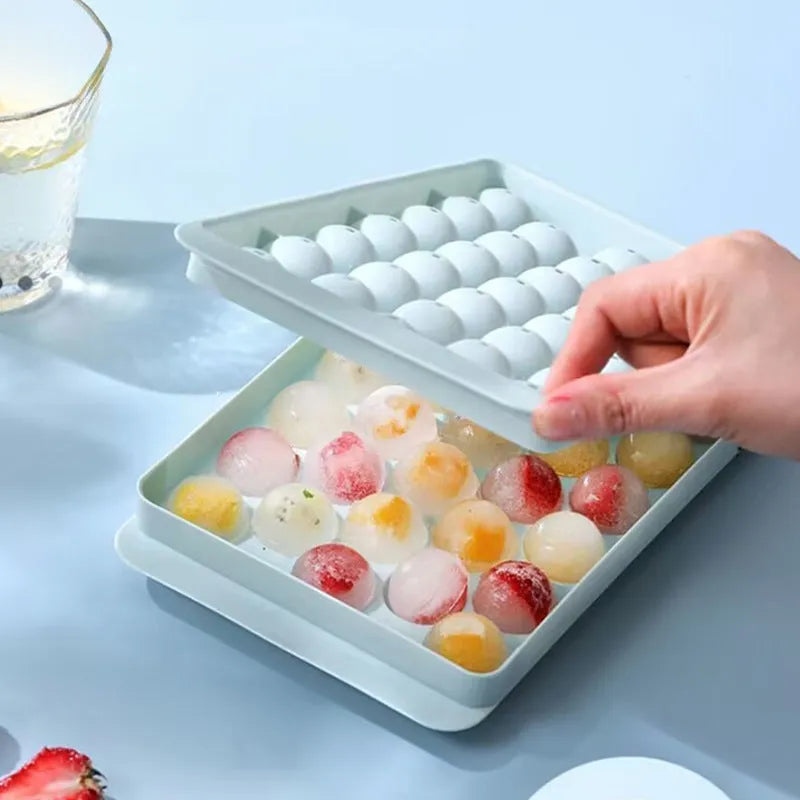 Large blue silicone ice cube tray with lid showing 33 round cavities.