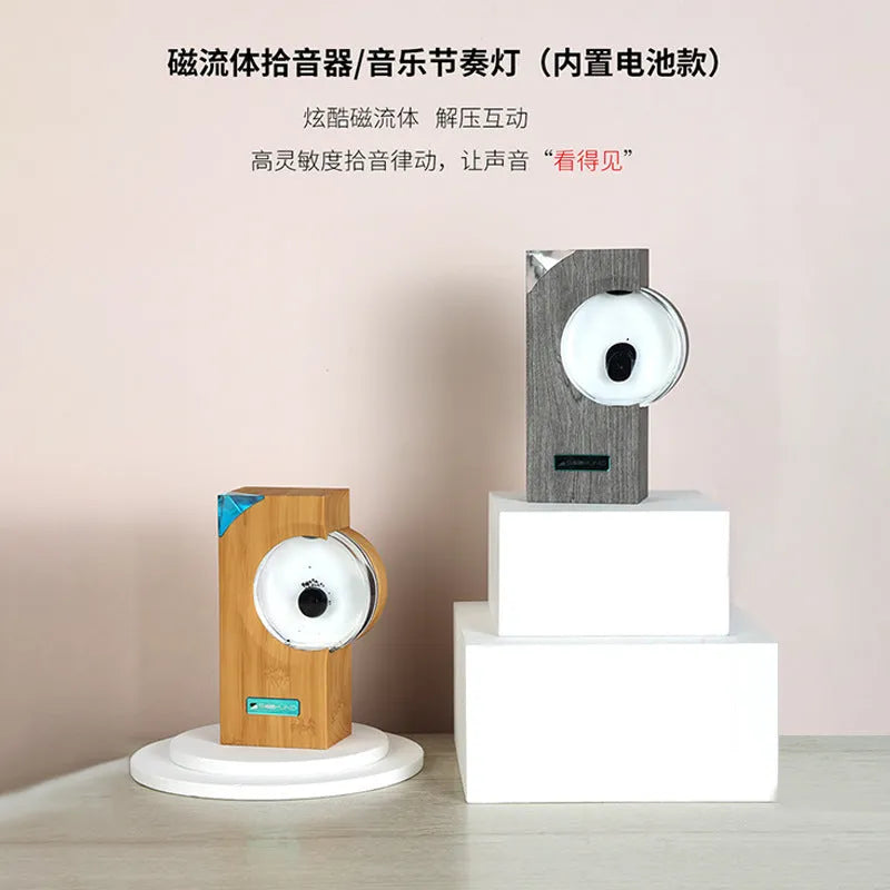 Ferrofluid speaker with magnetic fluid dancing in yellow plastic housing on desk