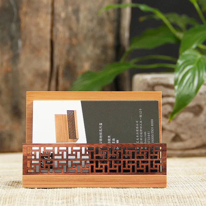 Geometric bamboo and black walnut business card holder on a desk