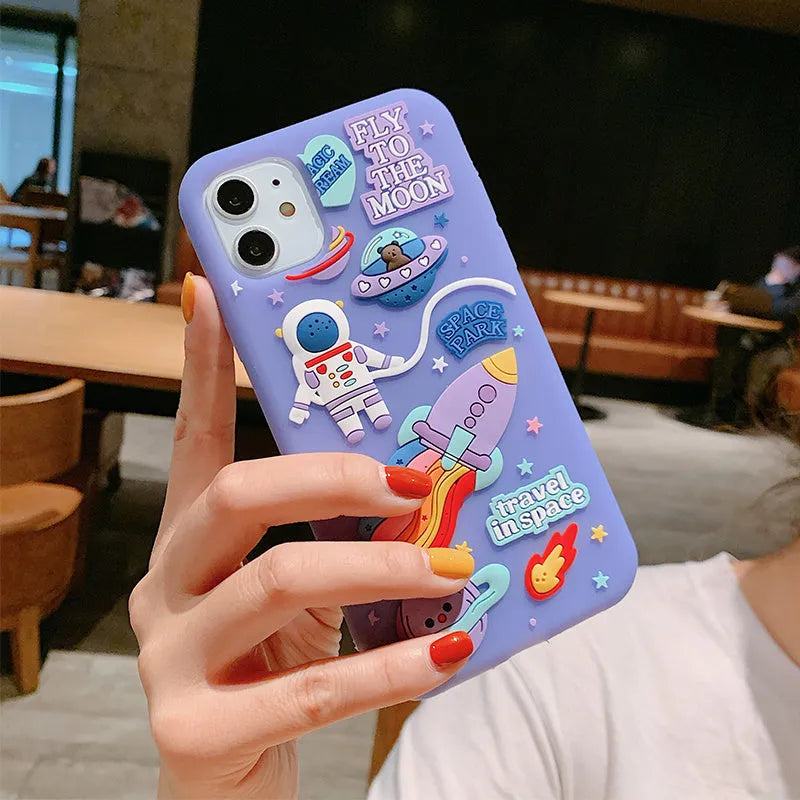 Purple silicone iPhone case with cartoon astronaut spaceman design showing precise port cut-outs
