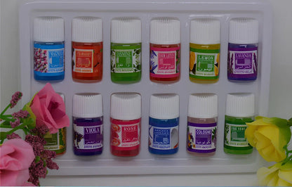 Box of 12 round plastic aromatherapy oil bottles, 25-50mL, featuring lemon, rose, jasmine, lavender floral scents