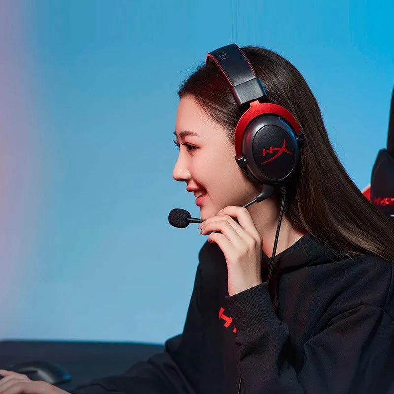 Wired gaming headset with detachable microphone and USB sound card remote in black red colour.
