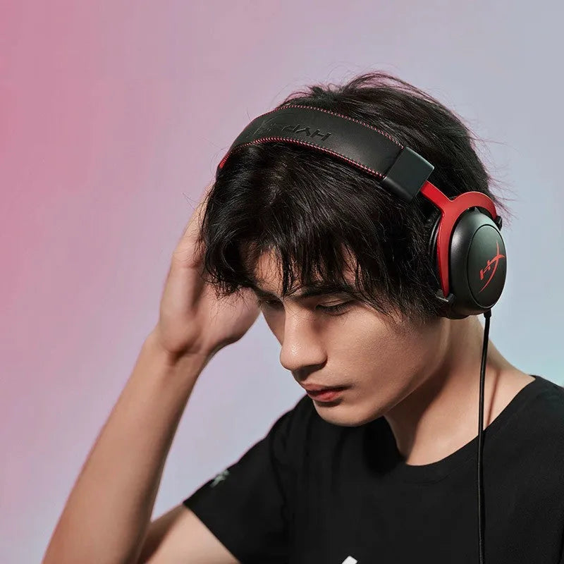 Wired gaming headset with detachable microphone and USB sound card remote in black red colour.