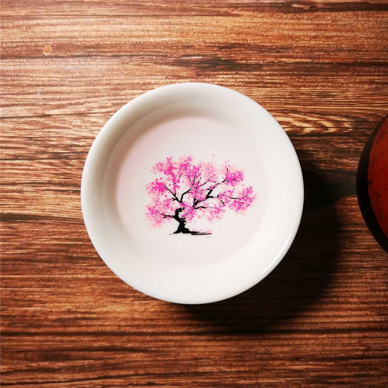 Magic Sakura Cup - Ceramic teacup with temperature-sensitive colour-changing sakura pattern
