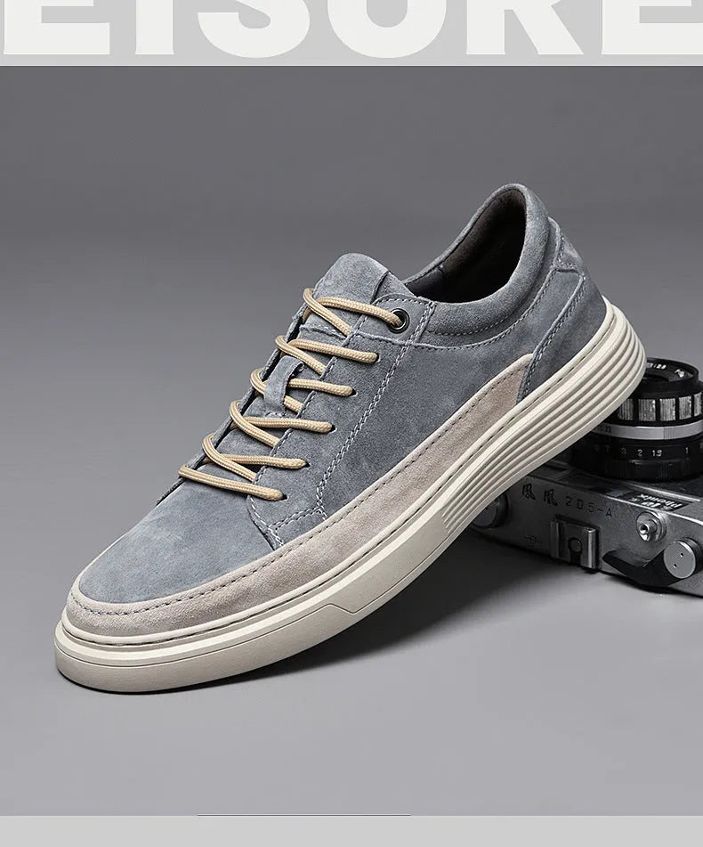 Men's grey pigskin leather low-top casual skate shoes with round toe and flat rubber sole.