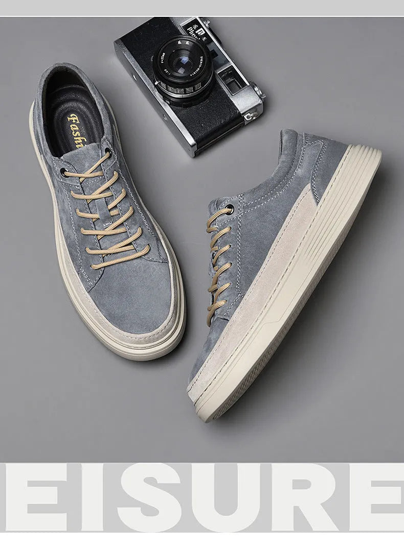Men's grey pigskin leather low-top casual skate shoes with round toe and flat rubber sole.