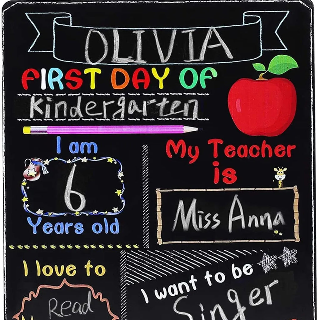 Black wooden First Day of School sign with white chalkboard text, measuring 25.5 by 30 centimetres.