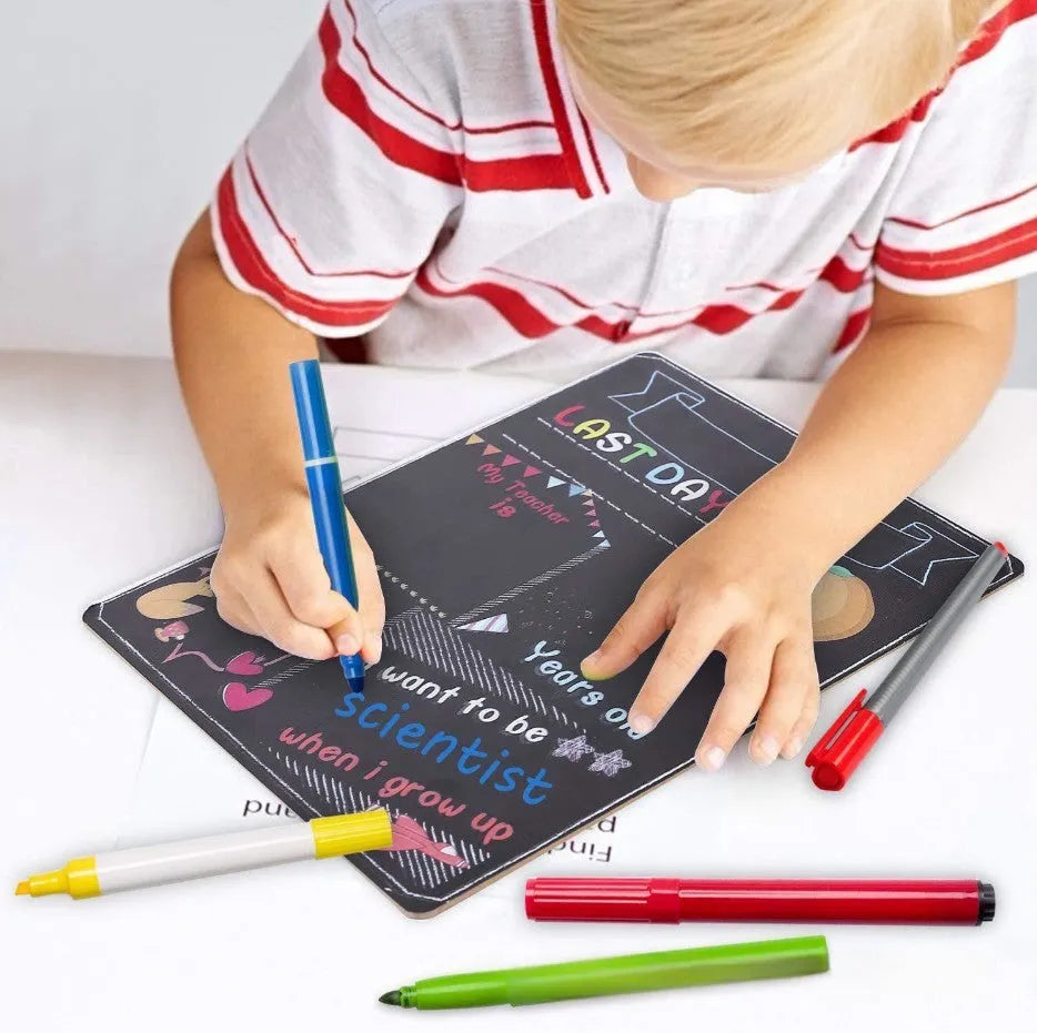 Black wooden First Day of School sign with white chalkboard text, measuring 25.5 by 30 centimetres.