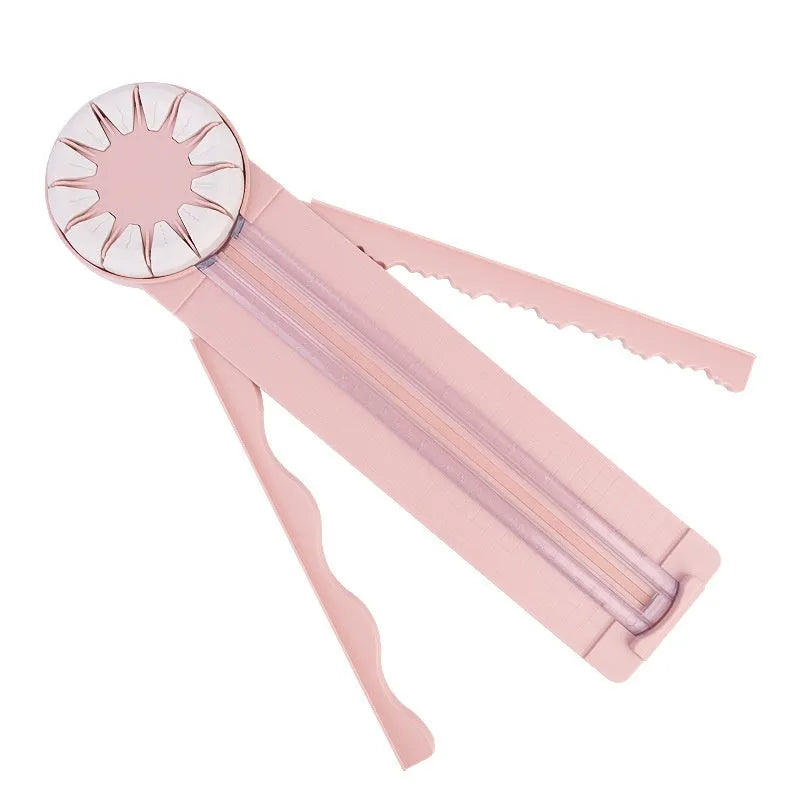 Pink and black 12-in-1 plastic dotted paper cutter on a white background.