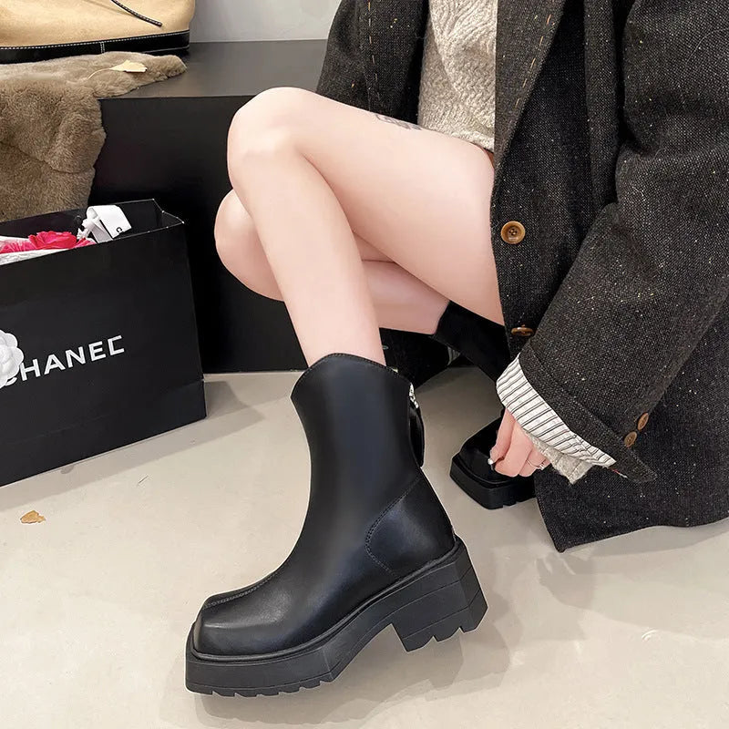 Women's black platform Martin boots with square toe and back zipper, showing 6-8cm heel