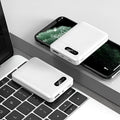 White and black portable power bank with multiple USB ports showing 10000mAh capacity label