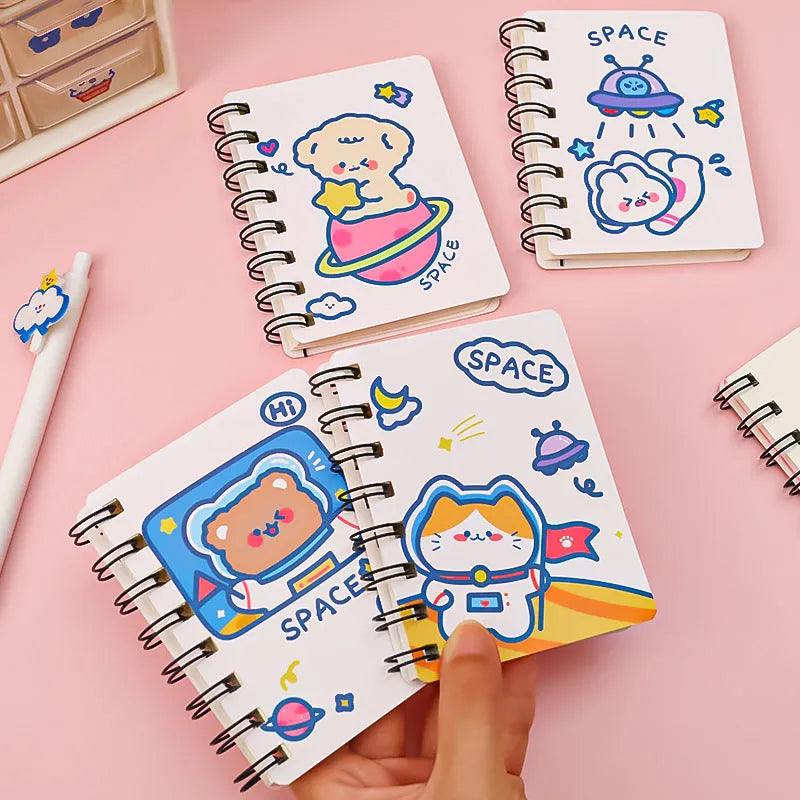 Astronaut themed pocket flipper notebook showing 10.5 by 8 cm dimensions with space cat cover design