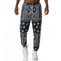 Printed jogging pants in loose fit with digital print pattern, mid waist, drawstring belt, and small-foot ribbed hem