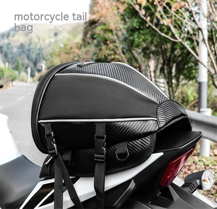 Black motorcycle seat bag with reflective strip, showing convertible crossbody strap and internal pocket organisation