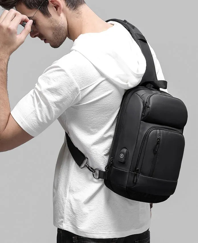 Black PVC outdoor shoulder bag with air cushion strap and internal organisation pockets