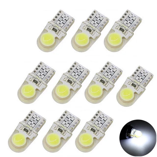 Ten silicone T10 LED car bulbs in various colours including white, red, blue, and yellow on a white background.