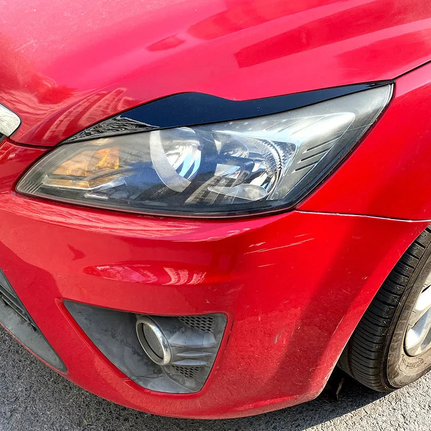 Pair of ABS plastic headlight eyebrow stickers for Ford Focus in carbon fibre pattern finish