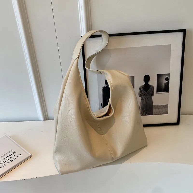 Soft PU leather large capacity shoulder bag in street style with sandwich pocket.