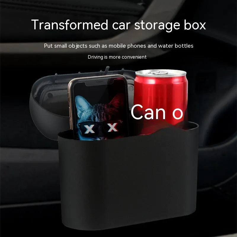 Black folding plastic car trash can shown in a vehicle footwell.
