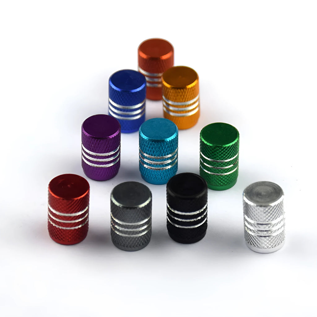 Set of coloured aluminium alloy car tyre valve caps in stainless steel on a grey background.