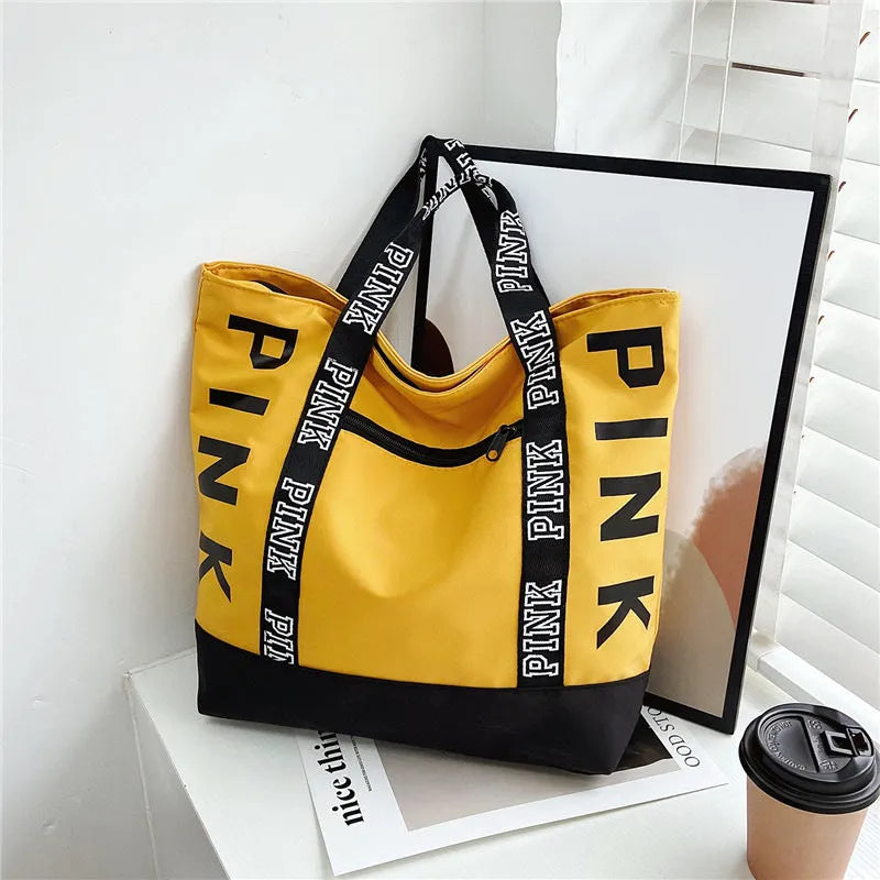 Soft canvas handbag with large capacity, horizontal square shape, double shoulder straps, and sandwich pocket in pink