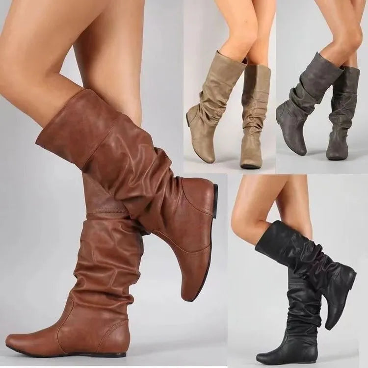 Women's black slip-on flat ankle boots with round toe and high calf.