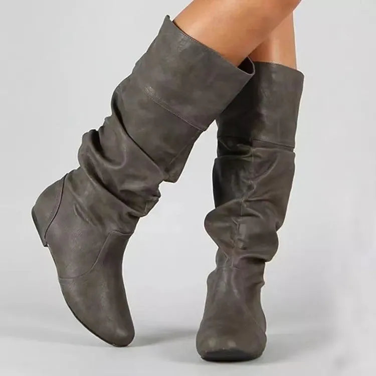 Women's black slip-on flat ankle boots with round toe and high calf.