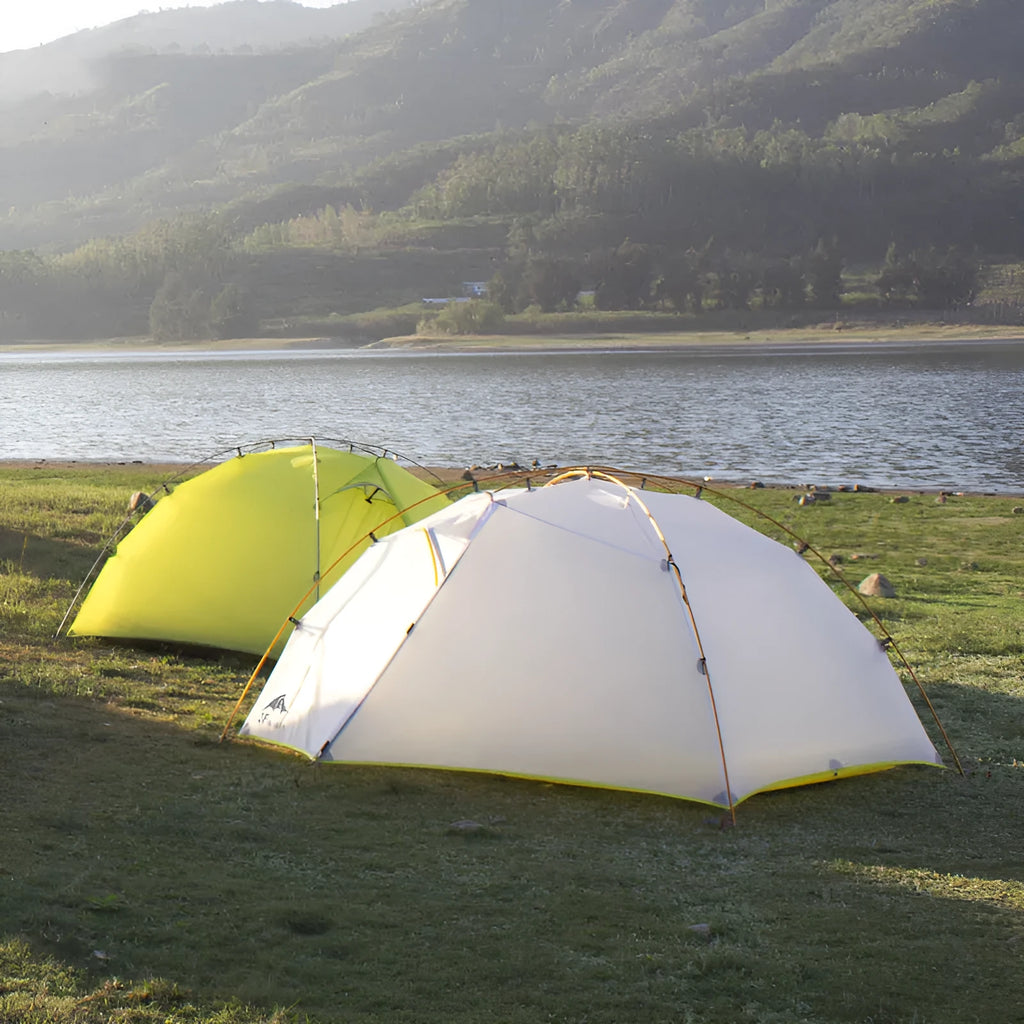 Double layer camping tent in dark green camouflage with two rooms and one hall, aluminium alloy poles, set up outdoors