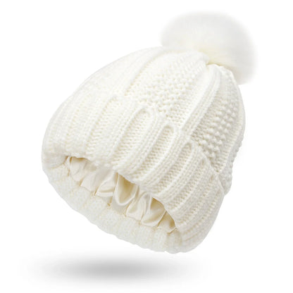 Wool skull knit beanie with satin lining and faux fur pom pom in various colours