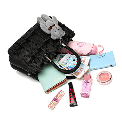 Women's black PU leather shoulder handbag showing four internal organisational compartments and adjustable strap