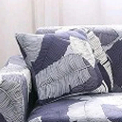 Printed stretchable sofa slipcover covering a three-seater sofa in a modern geometric pattern