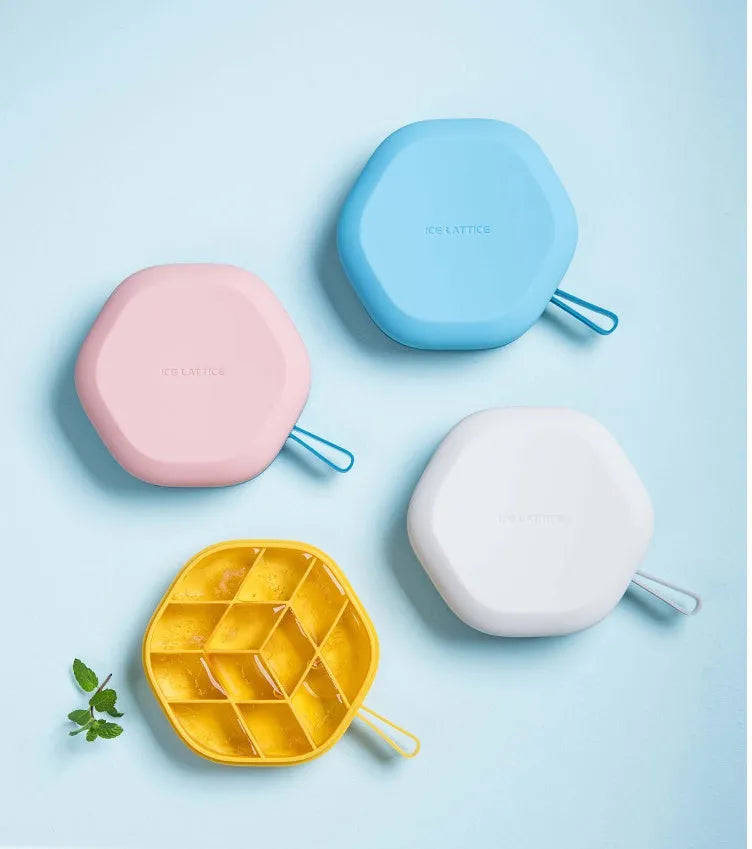 Blue silicone 12-cavity hexagon ice cube mould with silicone cover on white background