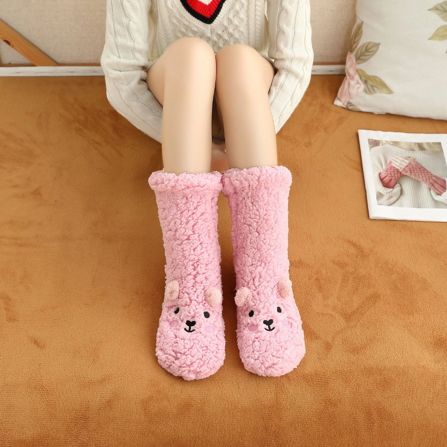 Cozy coral fleece socks in various colors, featuring a plush, insulating texture and non-slip grippy sole for comfortable home wear.