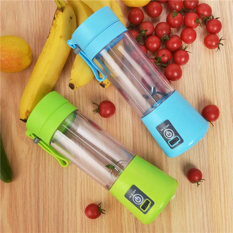 Mini USB-powered handheld fruit juicer with green plastic housing and a stainless steel blade.