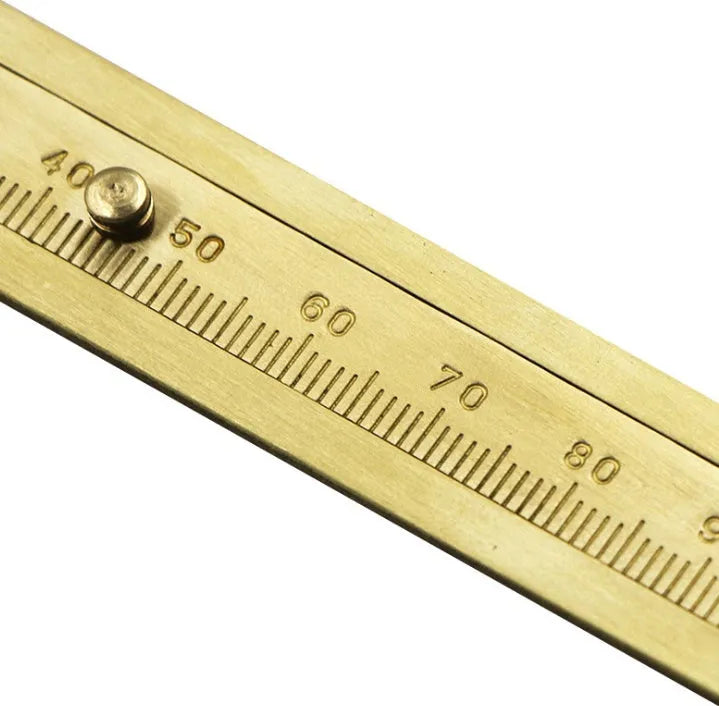 Double scale mini copper caliper with brass body, 100mm range, showing dual metric and imperial scales