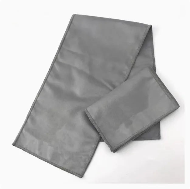 Cotton cleaning and polishing cloth 13 x 50 cm for shoe care, light colour, on a wooden surface