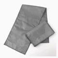 Cotton cleaning and polishing cloth 13 x 50 cm for shoe care, light colour, on a wooden surface