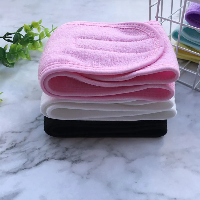 Thickened ant fabric beauty headband in white, pink, blue, purple, yellow on soft surface
