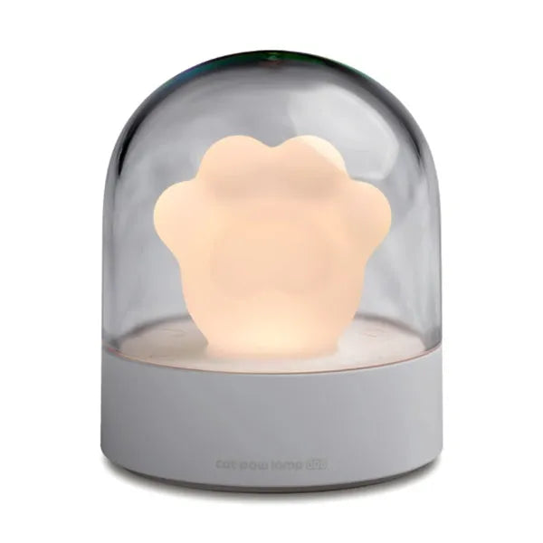 Grey cat paw shaped USB rechargeable night light with music box feature on wooden desk