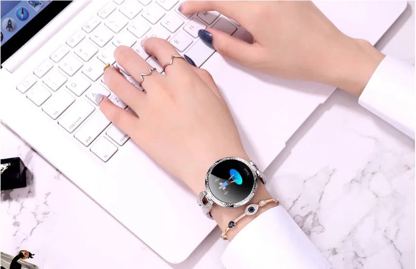 Fashion women's smart watch with round LCD screen and stainless steel strap in Rose Gold
