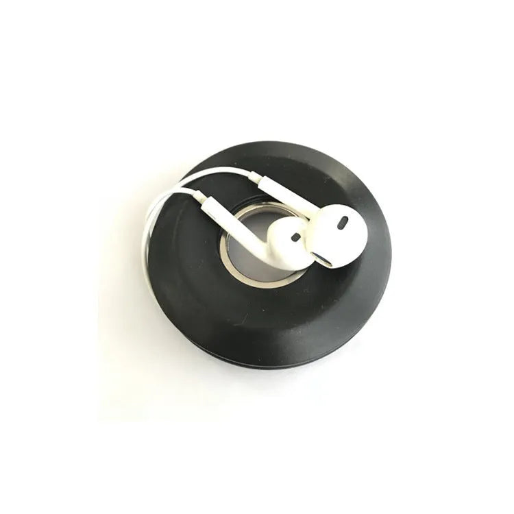 Donut-shaped silicone cord reel with suction cup base and magnet ring for organising cables