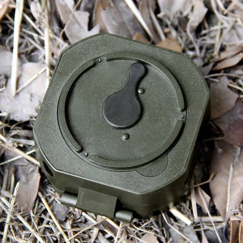 M2 outdoor professional geological compass in green with dimensions 140x83x116mm on a rocky surface
