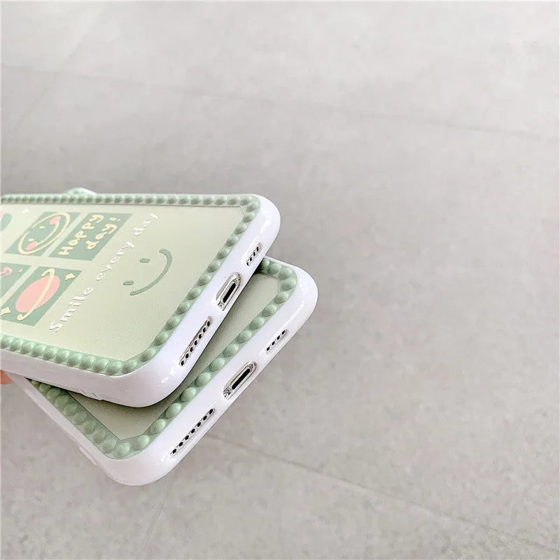 Green TPU iPhone back cover with geometric pattern featuring smiley faces and a polka dot frame.