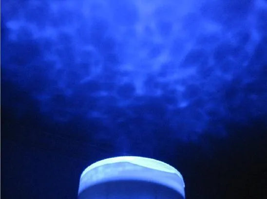 Blue ocean themed LED projection lamp for children's rooms on a shelf.