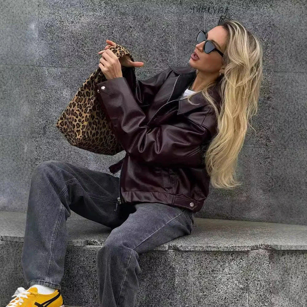 Stylish women's leather jacket with zipper detail in burgundy and black