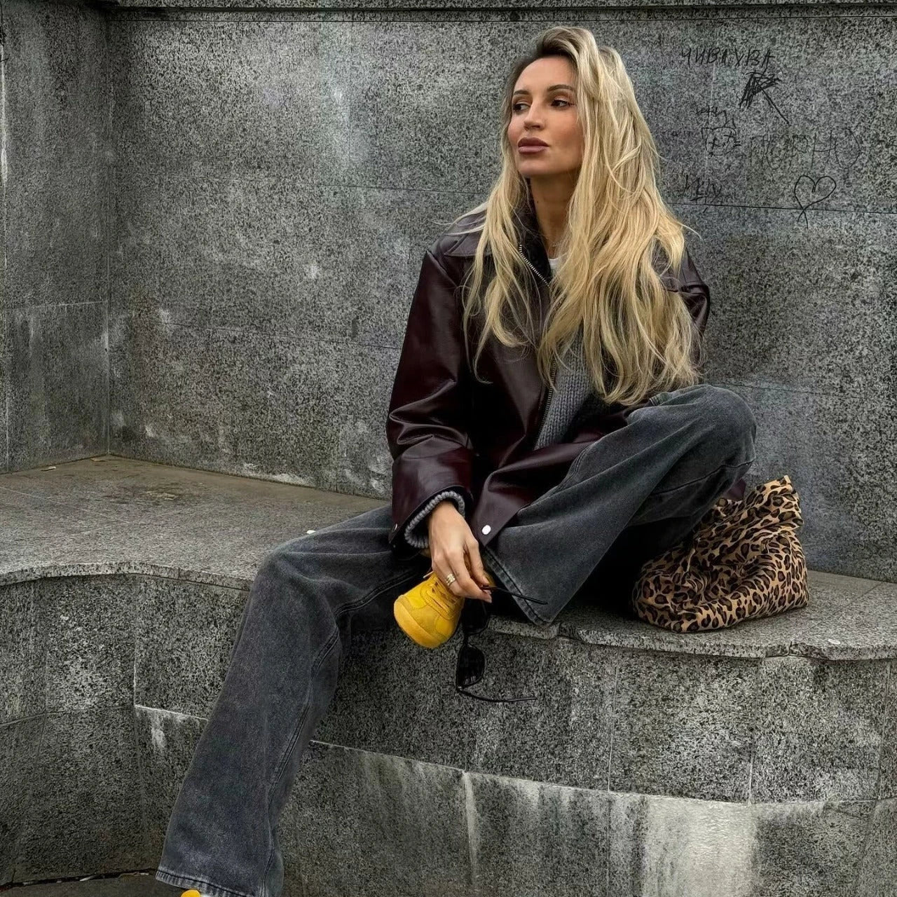 Stylish women's leather jacket with zipper detail in burgundy and black