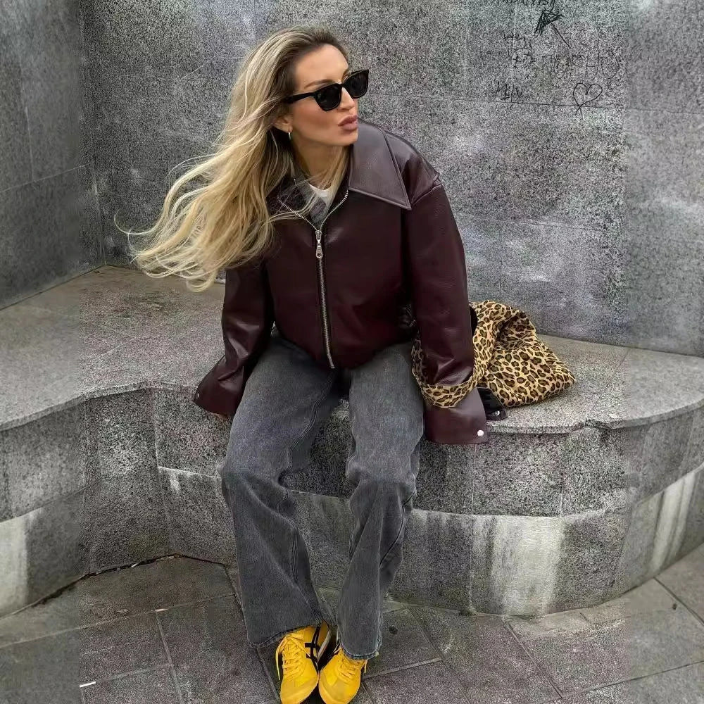 Stylish women's leather jacket with zipper detail in burgundy and black